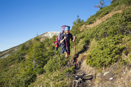 Two girls spend time together traveling through the mountains.の写真素材