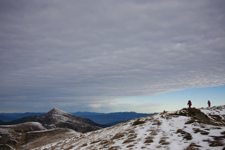 Two girls are traveling in the winter mountains.の写真素材
