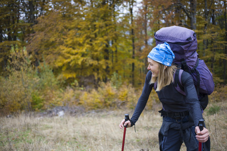 The girl with the backpack walking in the forest.の写真素材