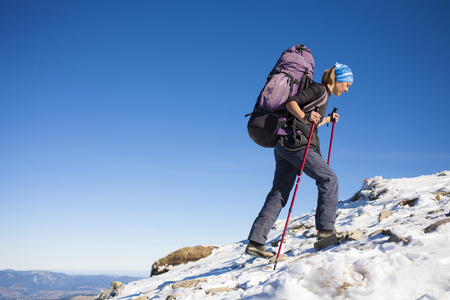 Tourist with a backpack is the snowy slope.の写真素材