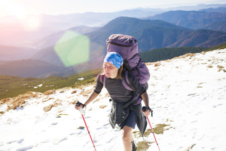 Girl with backpack is traveling in the mountains.の写真素材