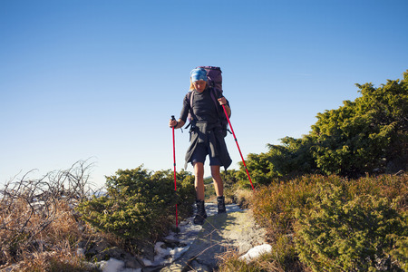 Girl with backpack is traveling in the mountains.の写真素材