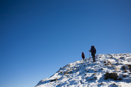 Two climbers are on a dangerous snow slope.の写真素材