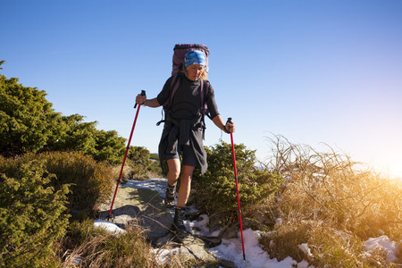Girl with backpack is traveling in the mountains.の写真素材