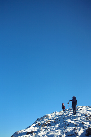 Two climbers are on a dangerous snow slope.の写真素材