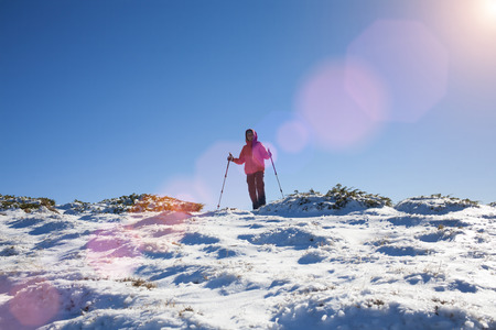 Young and beautiful girl is resting in the mountains in winter.の写真素材