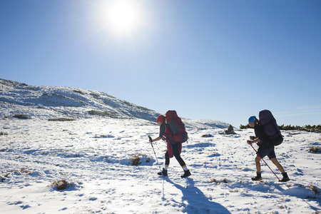 Two sports girls do Hiking in the mountains.の写真素材