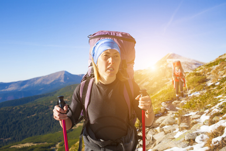 Two sports girls do Hiking in the mountains.の写真素材