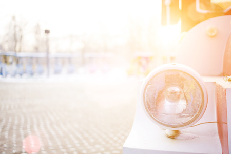 Car headlight covered with snow at close rangeの写真素材