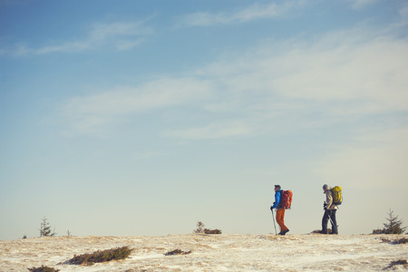 Two climbers with backpacks go towards my goal.の写真素材
