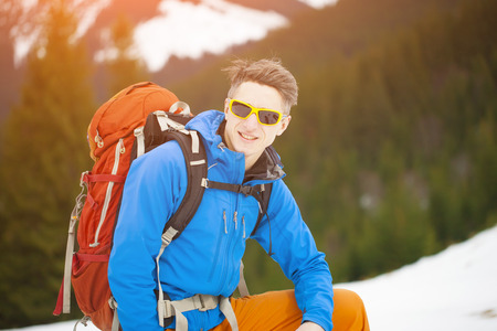 Portrait of a traveler with a backpack on a background of mountains.の写真素材