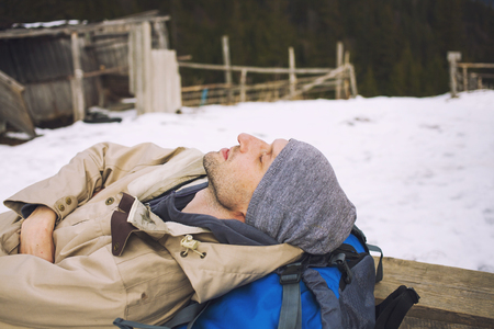 Man with a backpack goes through the dark forest.の写真素材