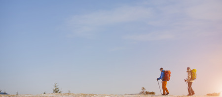 Two climbers with backpacks go towards my goal.の写真素材