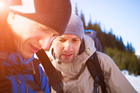 Friends discuss the route of his journey through the mountains.の写真素材