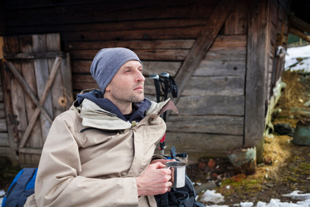 A person is resting in the camp during a hike in the mountains.