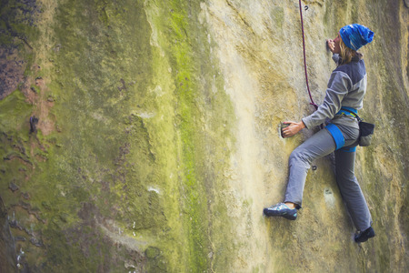 Girl engaged in rock climbing on the cliffs.の写真素材