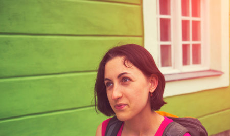 Portrait of a girl with a backpack who walks down the street.の写真素材