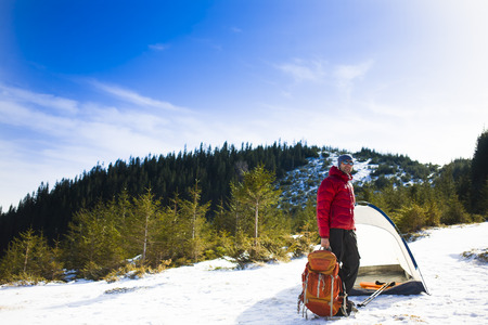 Climber with a backpack near the tent and preparing for the ascent.の写真素材
