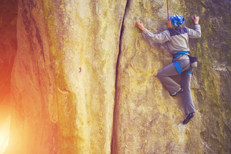 Girl engaged in rock climbing on the cliffs.の写真素材