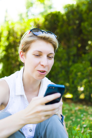 Girl in stylish glasses talking on the phone.の写真素材