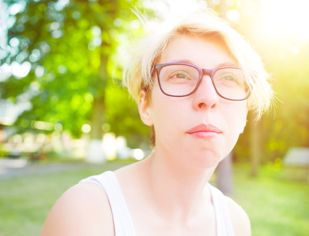 Portrait of a young girl with blond hair and stylish glasses.の写真素材
