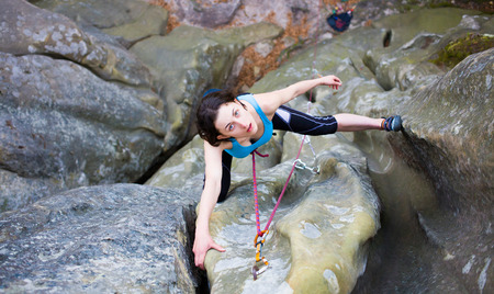 Girl rock climber climbs difficult route on the cliffs.の写真素材