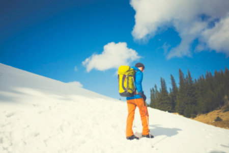 Adventure man hiking wilderness mountain with backpack, outdoor lifestyle survival vacation.