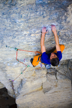 athletic man climbing the mountains, playing sports in nature.の写真素材