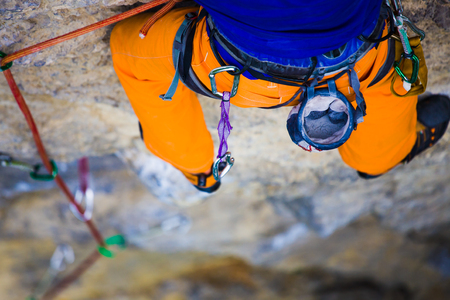 athletic man climbing the mountains, playing sports in nature.の写真素材