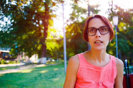 Portrait of a girl with dark hair in stylish glasses in daylight.の写真素材