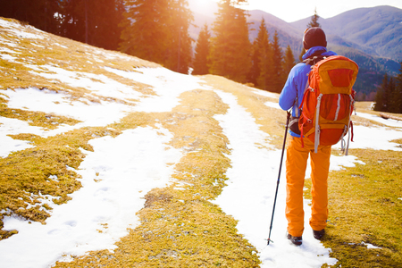 Adventure man hiking wilderness mountain with backpack, outdoor lifestyle survival vacation.の写真素材
