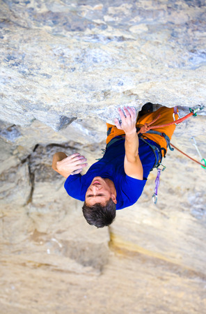 athletic man climbing the mountains, playing sports in nature.の写真素材