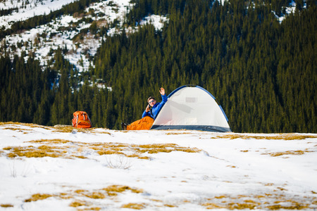 Climber jumps near the tent after a successful ascent.の写真素材