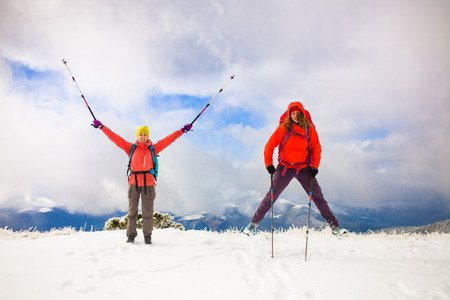 tourists jump in the snow in the mountains during the winter holidays in the mountains, winter in the Ukrainian Carpathians.

の写真素材