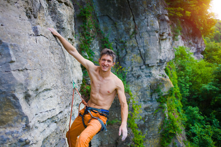 rock climber climbs the cliff using ropes and equipment, the employment of sports climbing.の写真素材