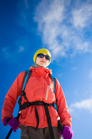 portrait of a girl climber in glasses, winter holidays in the mountains.の写真素材