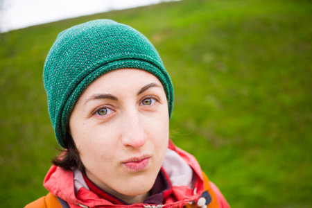 the girl in a warm hat during a walk in nature.