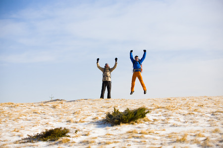 Climbers jumping for joy after a hard climb.の写真素材