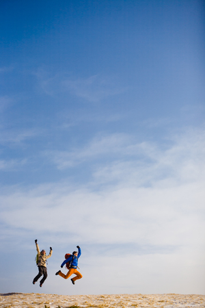 Climbers jumping for joy after a hard climb.の写真素材