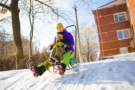 a mom with a child sledding in the fresh winter air, the child in protective glasses.
の写真素材