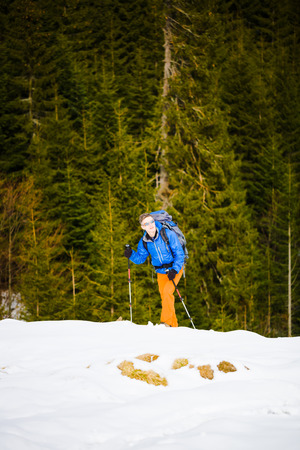 the young man went camping in the snow, the climber with a big backpack goes on the track.
の写真素材