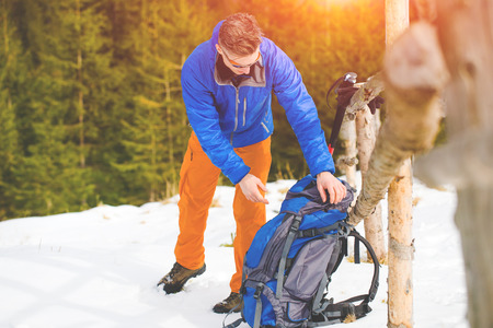 climber looking for things in a backpack during a winter hike in the mountains.
の写真素材