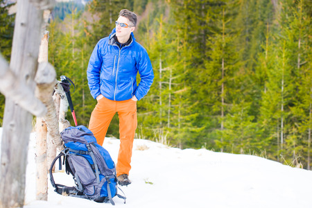 the young man went camping in the snow, the climber with a big backpack goes on the track.
の写真素材