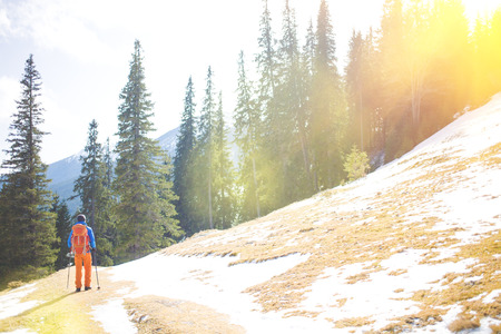 The climber is on a snowy hill during a winter hike.の写真素材
