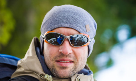 portrait of a young climber glasses, active rest on the nature.