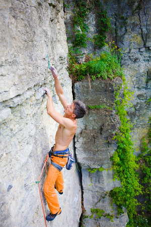 rock climber climbs the cliff using ropes and equipment, the employment of sports climbing.の写真素材