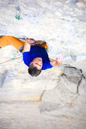 athletic man climbing the mountains, playing sports in nature.の写真素材