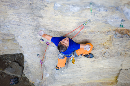 rock climber climbs the cliff using ropes and equipment, the employment of sports climbing.の写真素材