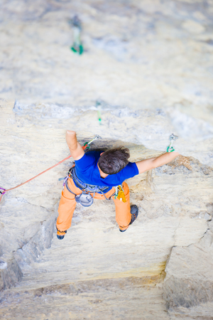 rock climber climbs the cliff using ropes and equipment, the employment of sports climbing.の写真素材