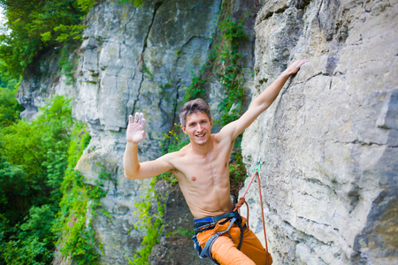 rock climber climbs the cliff using ropes and equipment, the employment of sports climbing.の写真素材